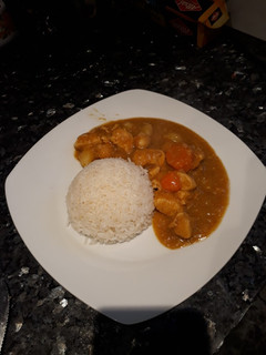 Una foto de Pollito al curry acompañado con arrocito blanco