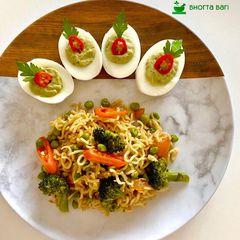 Maggie Noodles with egg and vegetables.Avocado Deviled Eggs A picture of Maggie Noodles with egg and vegetables.Avocado Deviled Eggs.