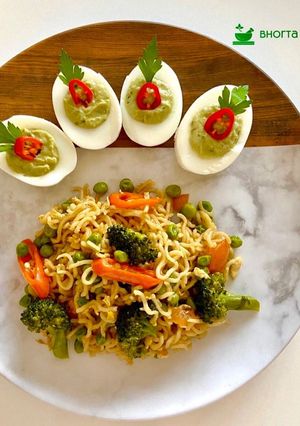 A picture of Maggie Noodles with egg and vegetables.Avocado Deviled Eggs.