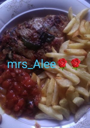 A picture of Chips, roasted fish and sauce.