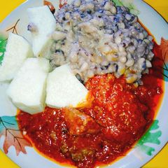A picture of Yam and beans with assorted meat stew.