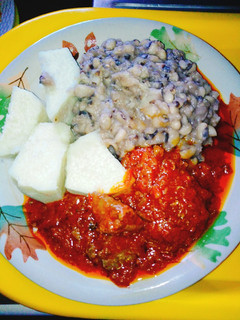 A picture of Yam and beans with assorted meat stew.
