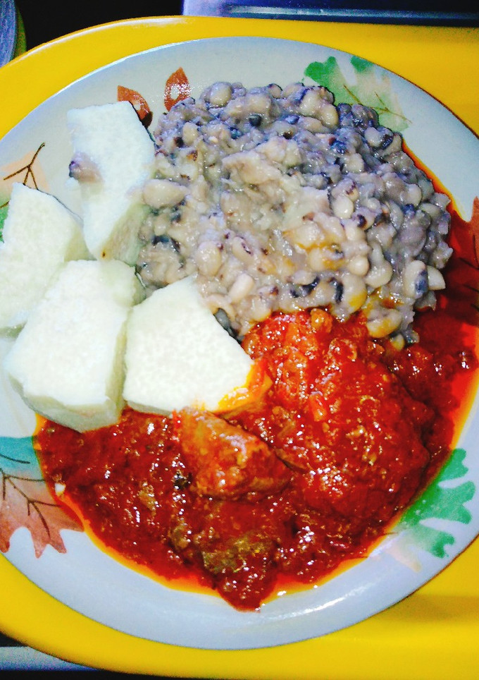 A picture of Yam and beans with assorted meat stew.
