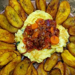 A picture of Fried plantain,scrambled eggs and carrot sauce.