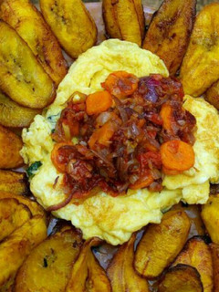 A picture of Fried plantain,scrambled eggs and carrot sauce.