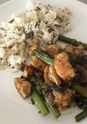 A picture of Chicken with asparagus, mushrooms and wild rice.