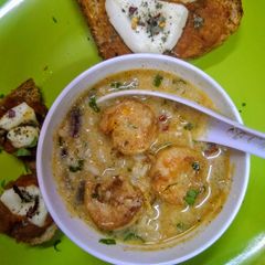 A picture of Scrumptious thai shrimps soup with red sauce bread.