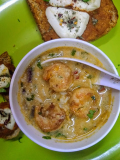 A picture of Scrumptious thai shrimps soup with red sauce bread.