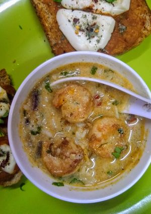 A picture of Scrumptious thai shrimps soup with red sauce bread.