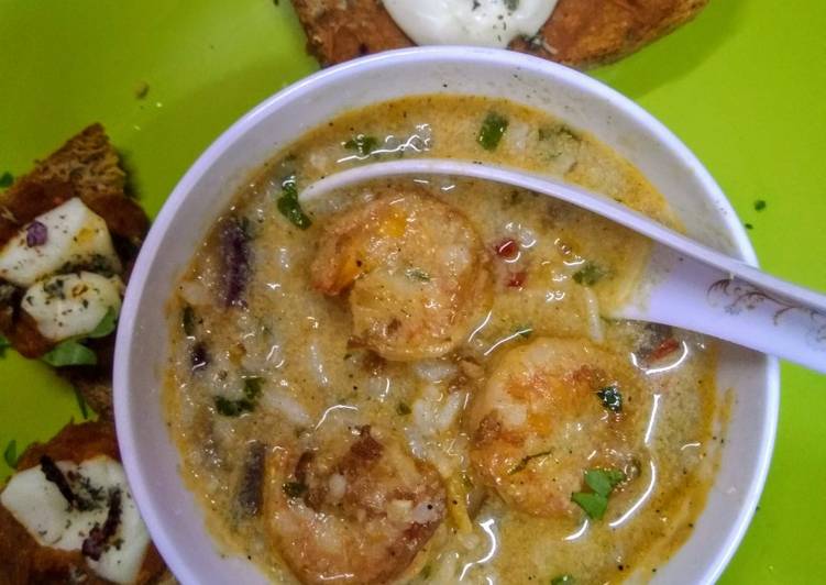 Homemade Scrumptious thai shrimps soup with red sauce bread