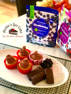 A picture of Vanilla cupcakes with chocolate buttercream frosting.