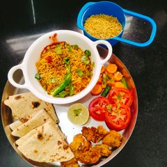 A picture of Sev tamatar nu shaak (Gujarati dinner sabji with phulka).