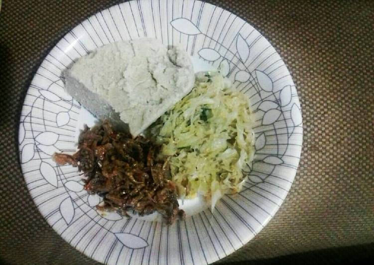 Cabbage garnished with dhania, wet fried omena and ugali