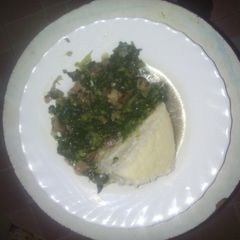 Ugali served with fried spinach mixed with beef meat A picture of Ugali served with fried spinach mixed with beef meat.
