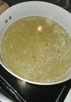 A picture of Pressure cooker chicken broth with frozen legs.