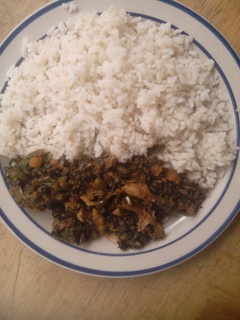 A picture of White rice garnish with vegetables sauce.