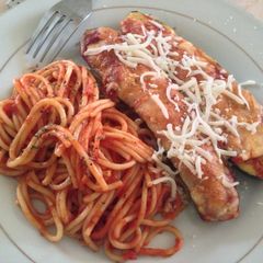 A picture of Zucchini Parmesan with Red Sauce.