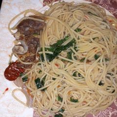 A picture of Spaghetti with green leaf.