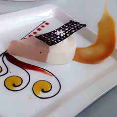 A picture of Chocolate mousse with a fruit sauce.