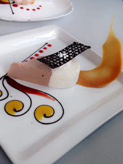 A picture of Chocolate mousse with a fruit sauce.