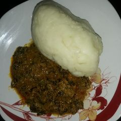 A picture of Egusi soup with pounded yam.