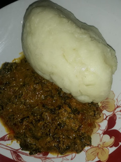 A picture of Egusi soup with pounded yam.