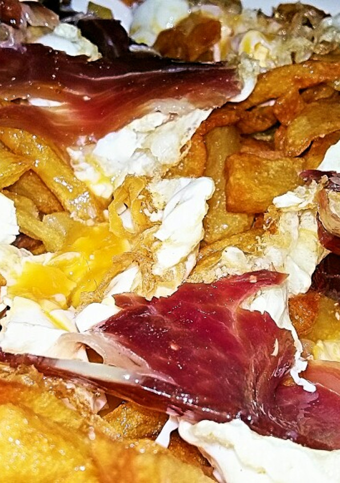 Una foto de Huevos rotos con jamón