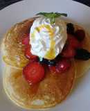 Pancakes with whipped cream and berries