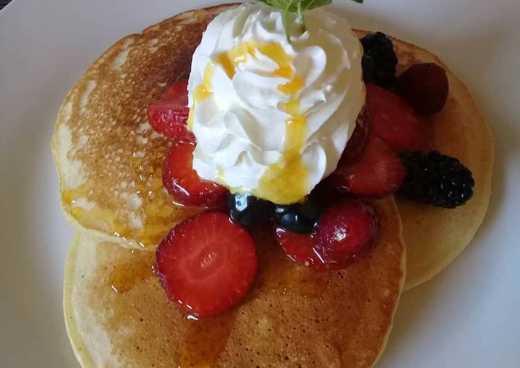 Pancakes with whipped cream and berries