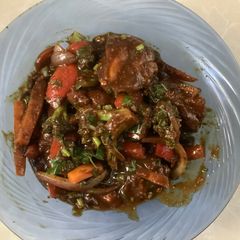 A picture of Chicken with veggies in peanut curry sauce.