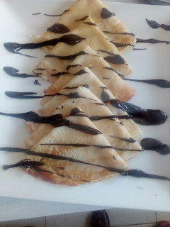 A picture of Crepes and chocolate sauce.