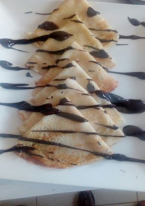 A picture of Crepes and chocolate sauce.