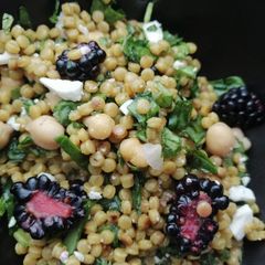 A picture of Giant cous cous, chickpeas, blackberry and feta salad.