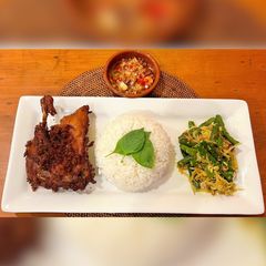 Bebek Bengil Bali with Spiced Coconut Vegetable Salad & Sambal Matah A picture of Bebek Bengil Bali with Spiced Coconut Vegetable Salad & Sambal Matah.