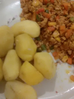 A picture of Boiled irish potatoes with egg sauce.