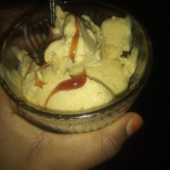 A picture of Banana ice cream with caramel glaze topping.