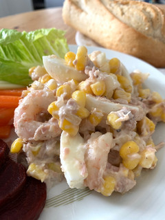 A picture of Tuna & Prawns salad with egg and sweet corns.