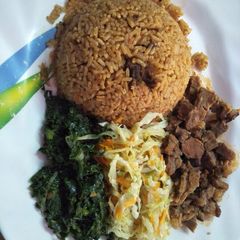 Pilau served with spinach, wet fried beef and steamed cabbage A picture of Pilau served with spinach, wet fried beef and steamed cabbage.