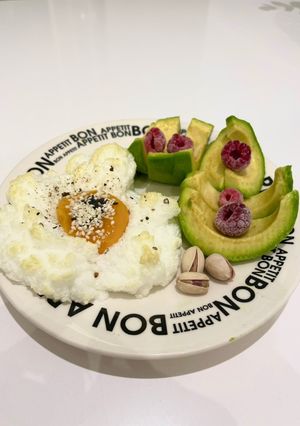 Una foto de Huevo nube con palta y un toque de frutos rojos y pistachos !