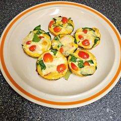 A picture of Egg Cups With Tomato, Swiss, and Spinach.