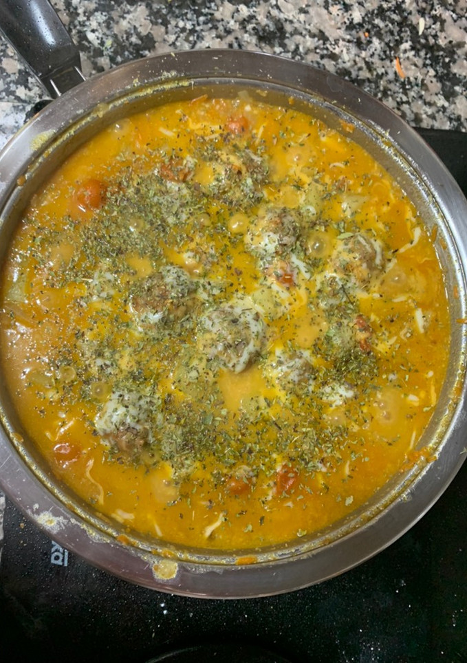 Una foto de Albóndigas rellenas de queso con salsa al queso y orégano