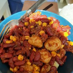 A picture of Gnocchi fried with beans and tomato.