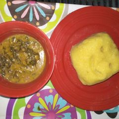 A picture of Bitterleaf soup with yellow garri.