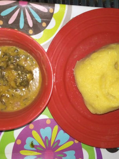 A picture of Bitterleaf soup with yellow garri.