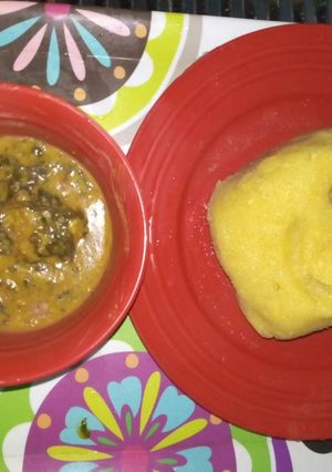 A picture of Bitterleaf soup with yellow garri.
