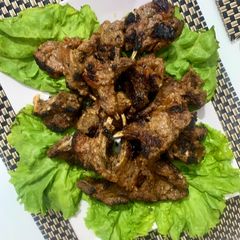 A picture of Grilled mutton chops dipped in herb and lemon peri peri sauce.
