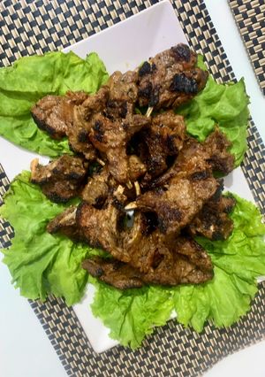 A picture of Grilled mutton chops dipped in herb and lemon peri peri sauce.