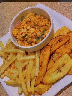A picture of Chips,plantains and egg sauce.