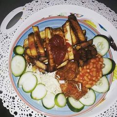 Fried sweet potatoes with cabbage,cucumber and baked beans A picture of Fried sweet potatoes with cabbage,cucumber and baked beans.
