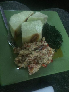 A picture of Boiled yam with egg sauce and vegetable.